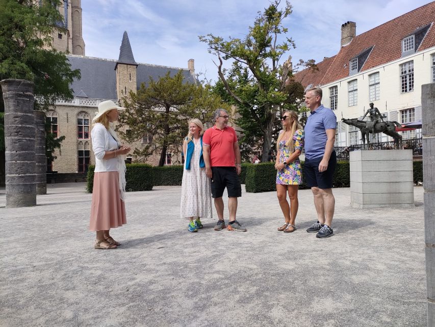 Bruges: Small Group Boat Cruise and Guided Walking Tour - The canal boat cruise: swans, ivy facades, and bridge views